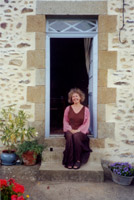 Michèle Roberts sitting in her garden